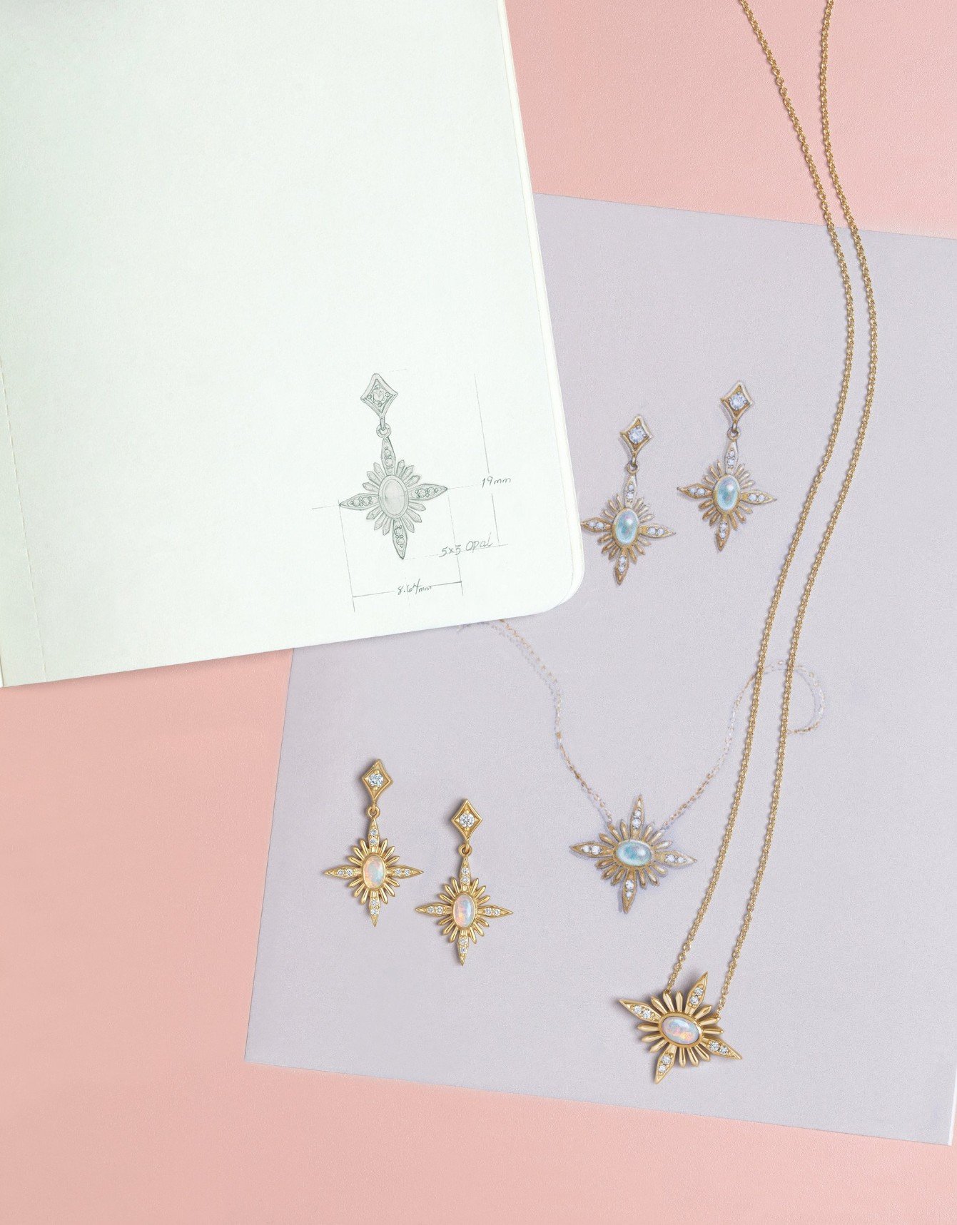 Jewelry set including a pair of earrings, a necklace, and a pendant, arranged on pastel pink and purple backgrounds with a sketch of the jewelry design in a notebook.