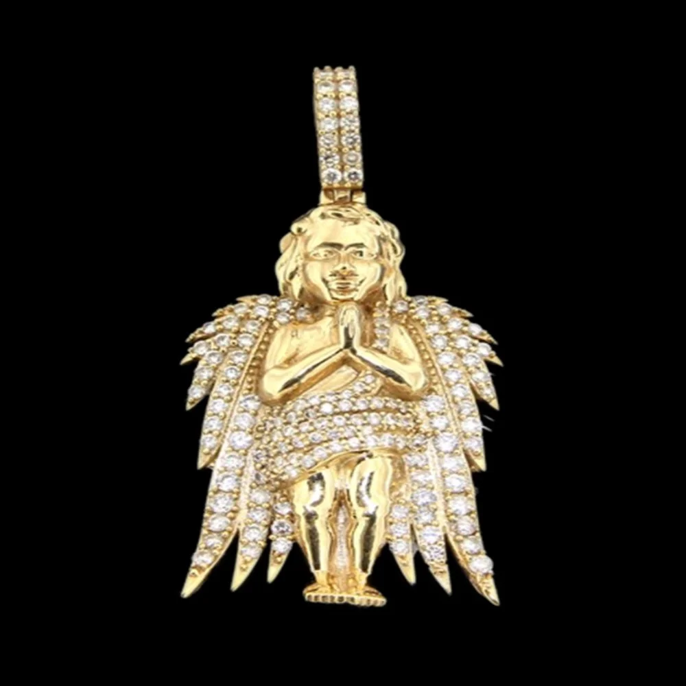 Gold pendant of a praying child with hands together, adorned with diamonds and a cape made of feathers, on a black background.