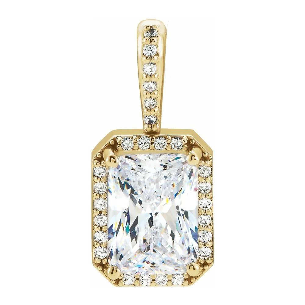 Gold pendant with a rectangular clear gemstone, surrounded by smaller diamonds, on a white background.