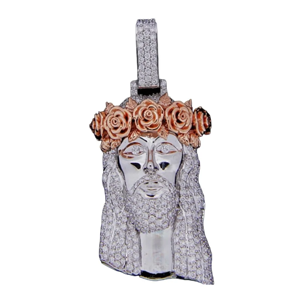 A gold and silver Jesus pendant with a crown of pink roses on his head, encrusted with diamonds.