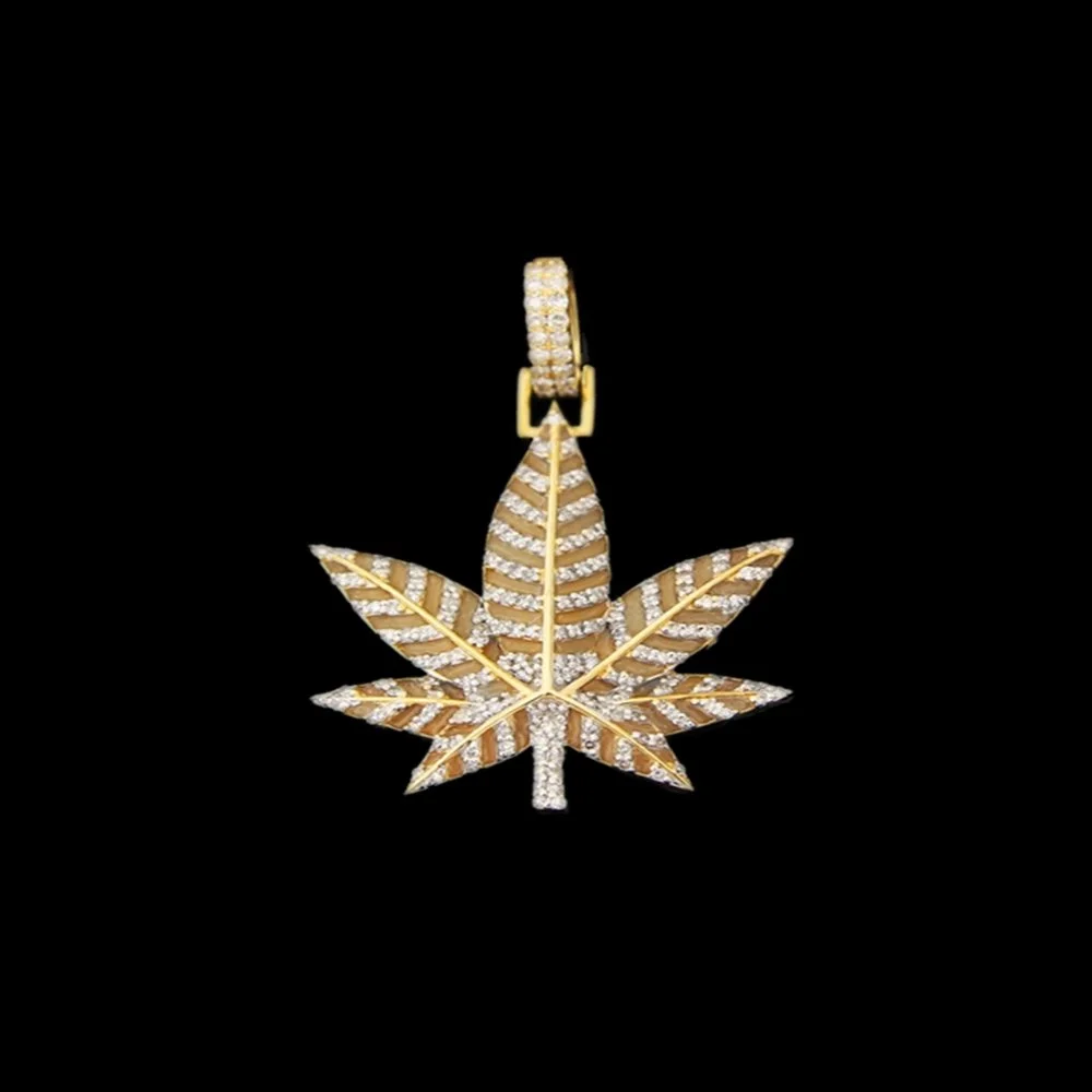 Gold and diamond pendant in the shape of a marijuana leaf.
