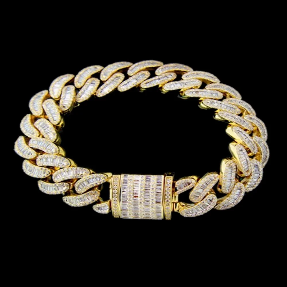 Gold chain bracelet with diamond embellishments on a black background.