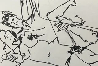 A line drawing of two people, one lying down and the other sitting, with minimal details.