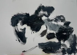 Abstract black and gray ink or paint strokes on a white background.