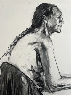 Side profile drawing of an elderly woman with long braided hair, seated and wearing a dark skirt.