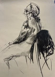 Sketch of a woman sitting sideways on a chair, with long hair and a relaxed posture.