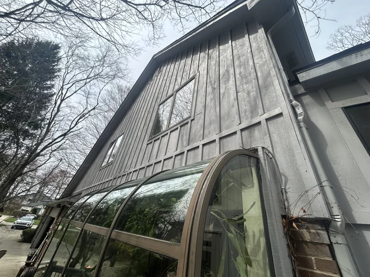 Shelby Township home with gray board-and-batten siding, exterior repainted