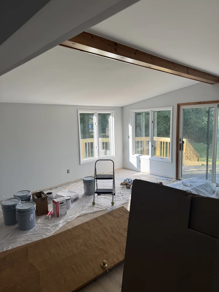 Vaulted ceiling room prepped and protected for painting