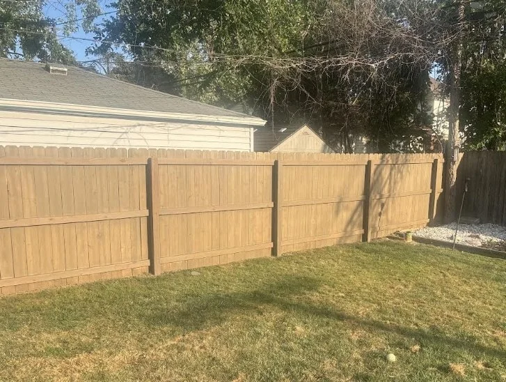 Freshly stained wood privacy fence