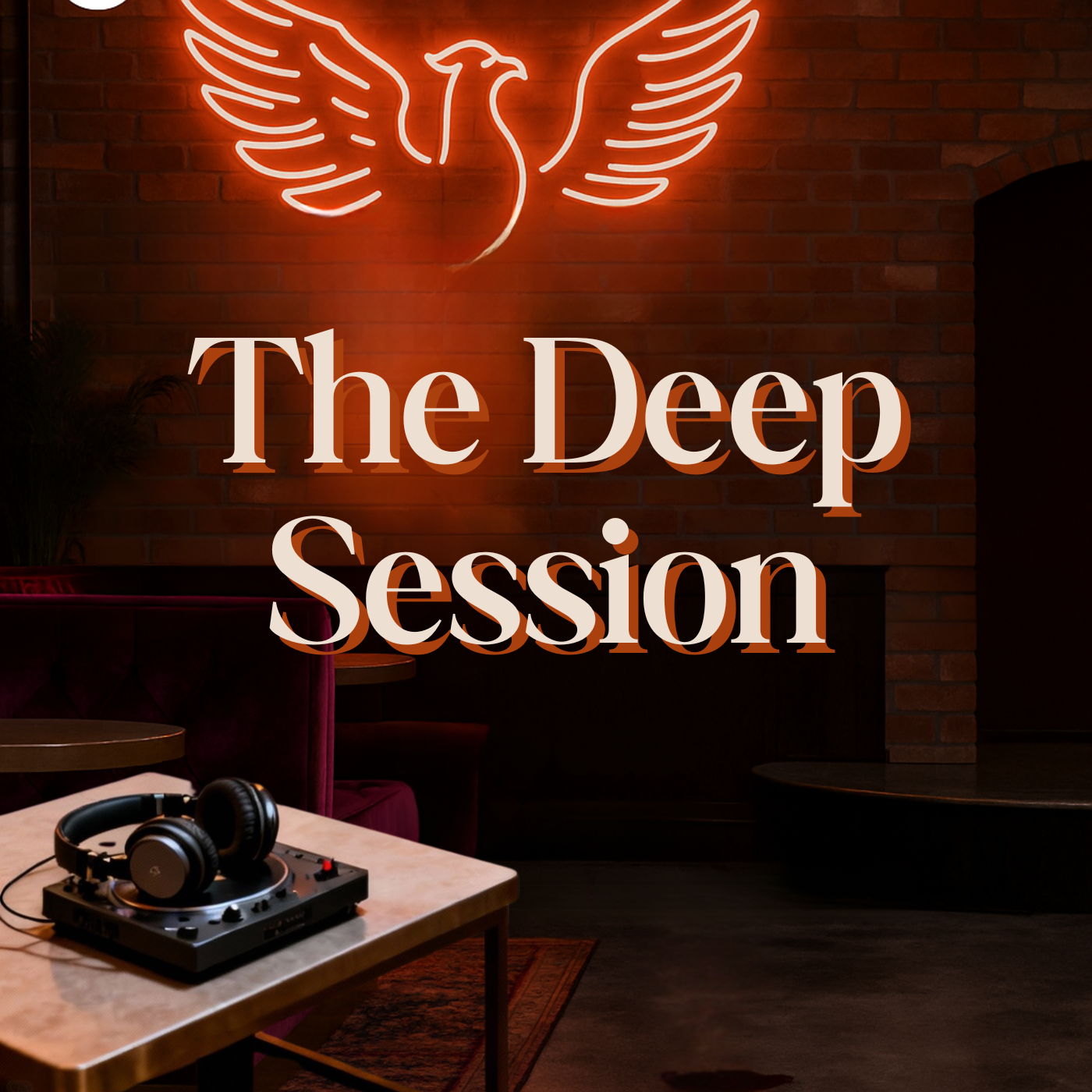 Neon sign of a phoenix above a sign that says "The Deep Session" in a dimly lit lounge or bar with a DJ turntable and headphones on a table in the foreground.