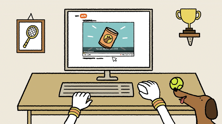 A computer desk with hands typing on a keyboard, a mouse in one hand, a dog with a ball in its mouth, a framed tennis racket picture on the wall, a trophy on a shelf, and a YouTube video on the monitor showing a snack can with a subtitle indicating an ad.