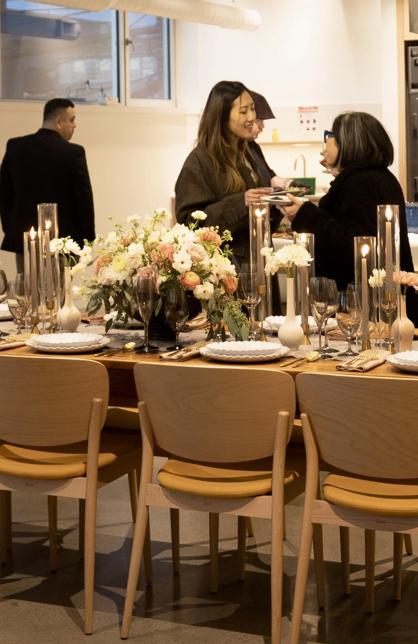 Women chatting at a party in the second floor hub