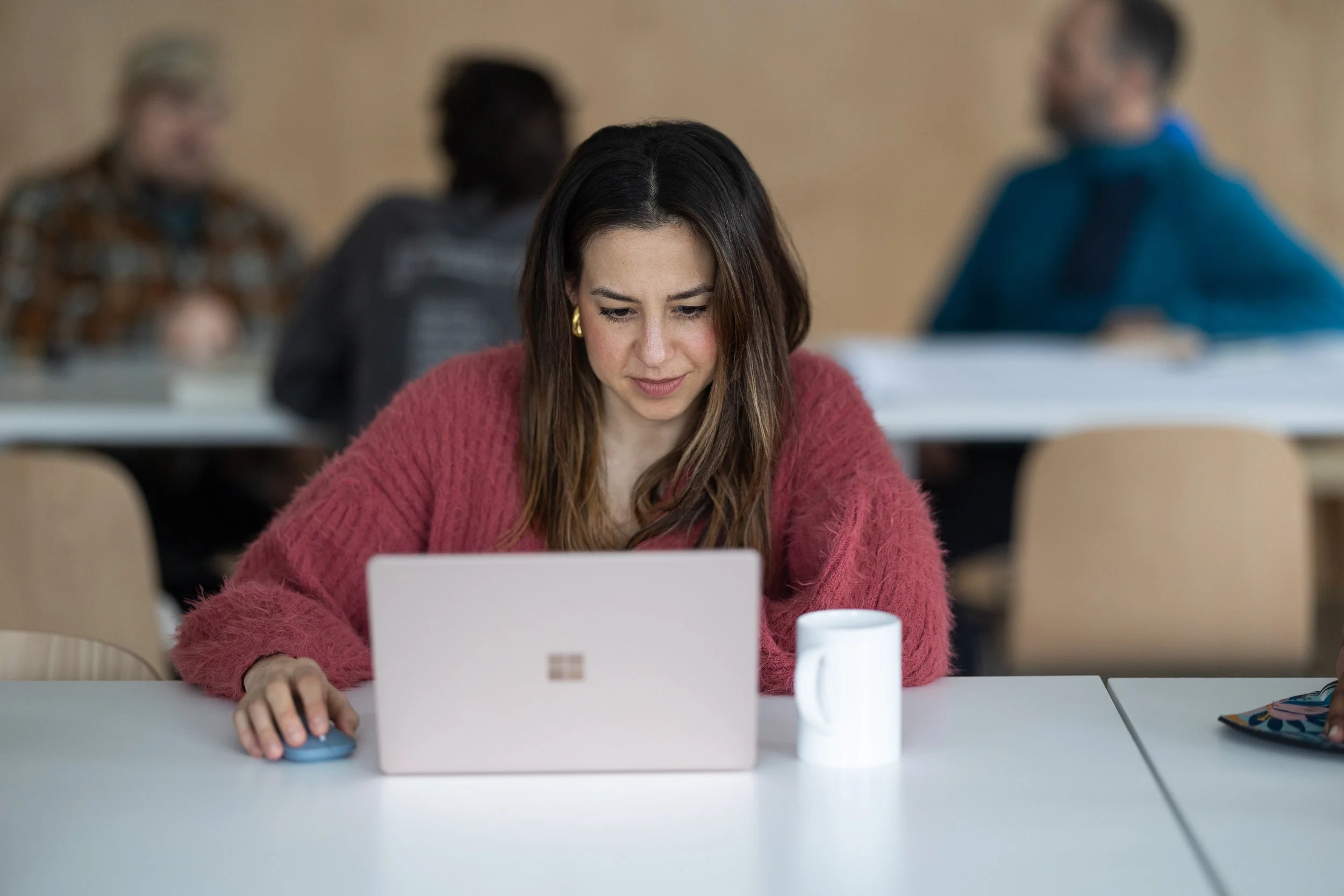Young woman typing on computer in The Spark CoLab