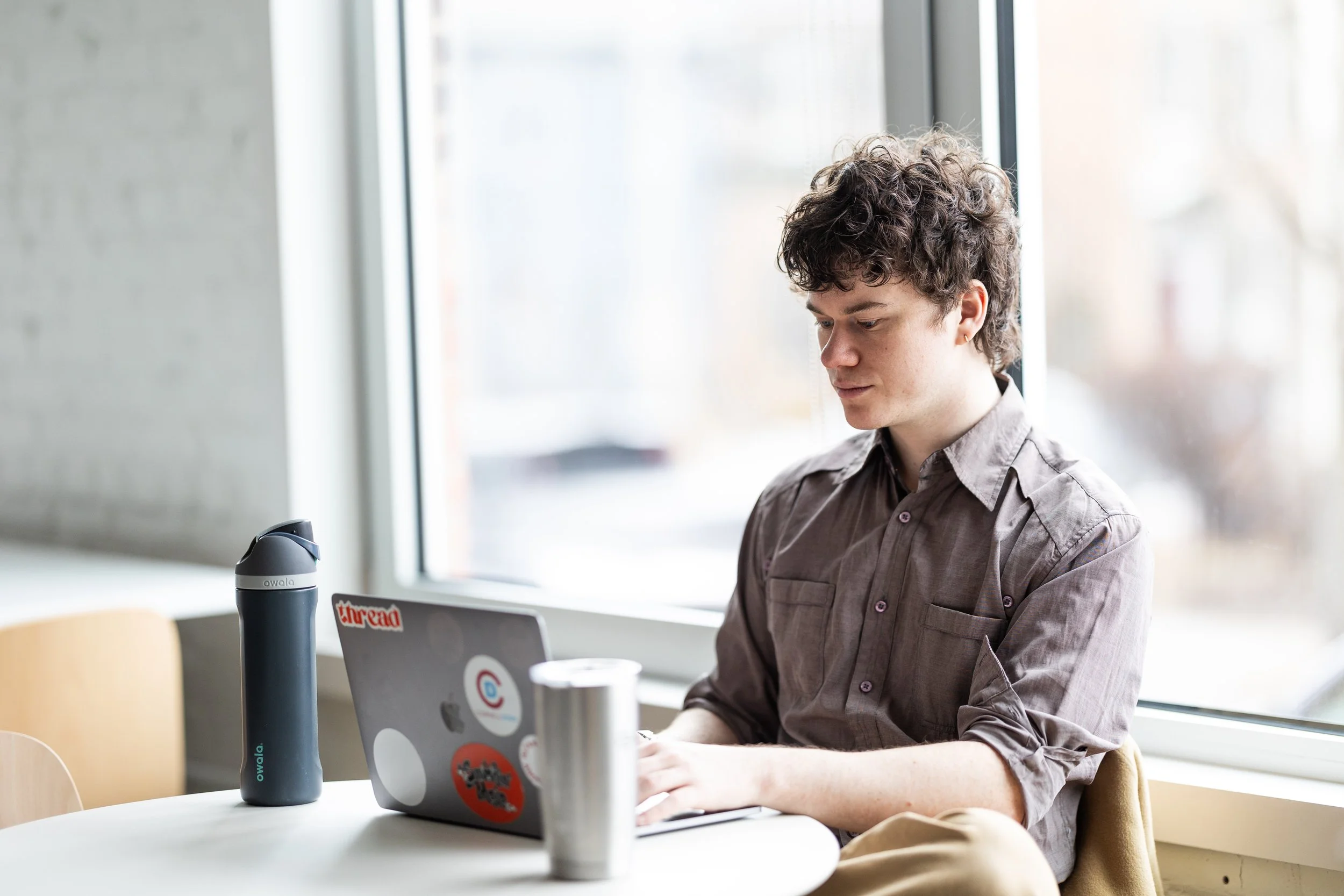 Young man typing on computer in The Spark CoLab