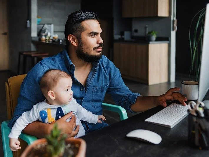 father working on computer