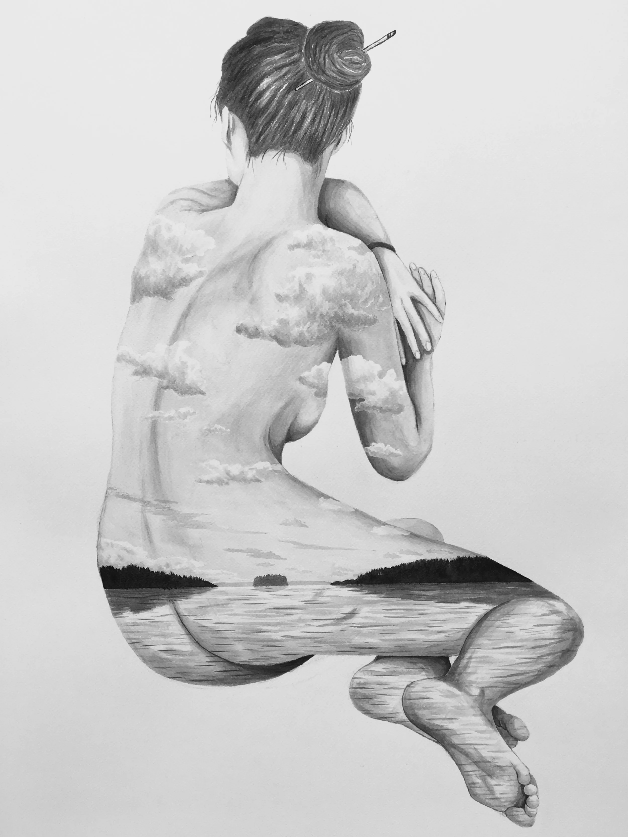 A woman with her back to the viewer, sitting cross-legged with her arms wrapped around her knees. Her back features a painted scene of clouds, trees, and a lake, blending natural landscape with her skin.