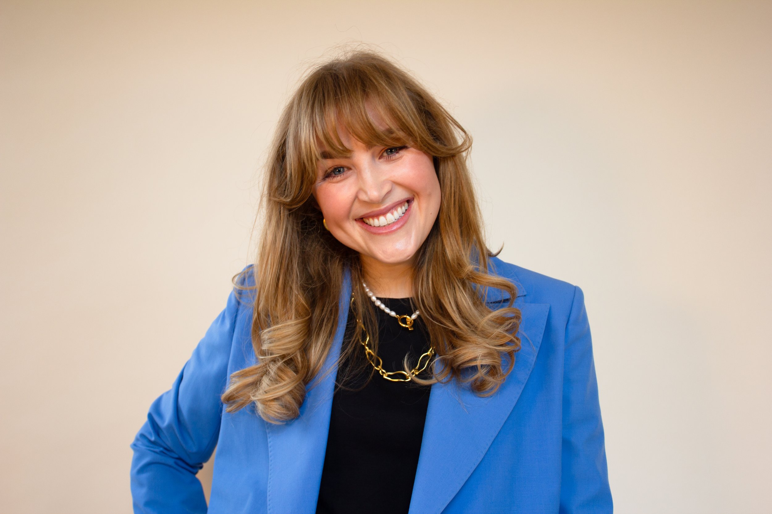 Hattie Willis, founder of GuessWorks, smiling in a blue blazer