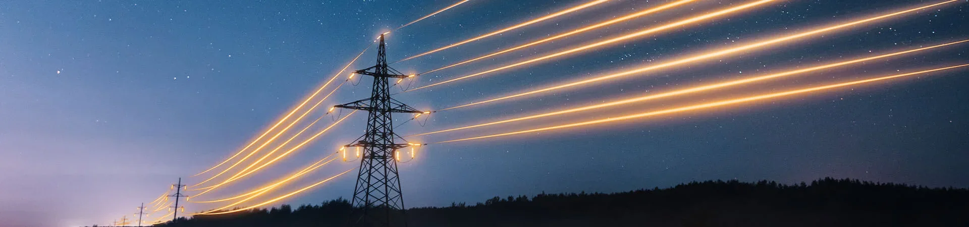 Multiple high-voltage power lines on electrical towers at night with streaks of lights from long exposure and a starry sky in the background.