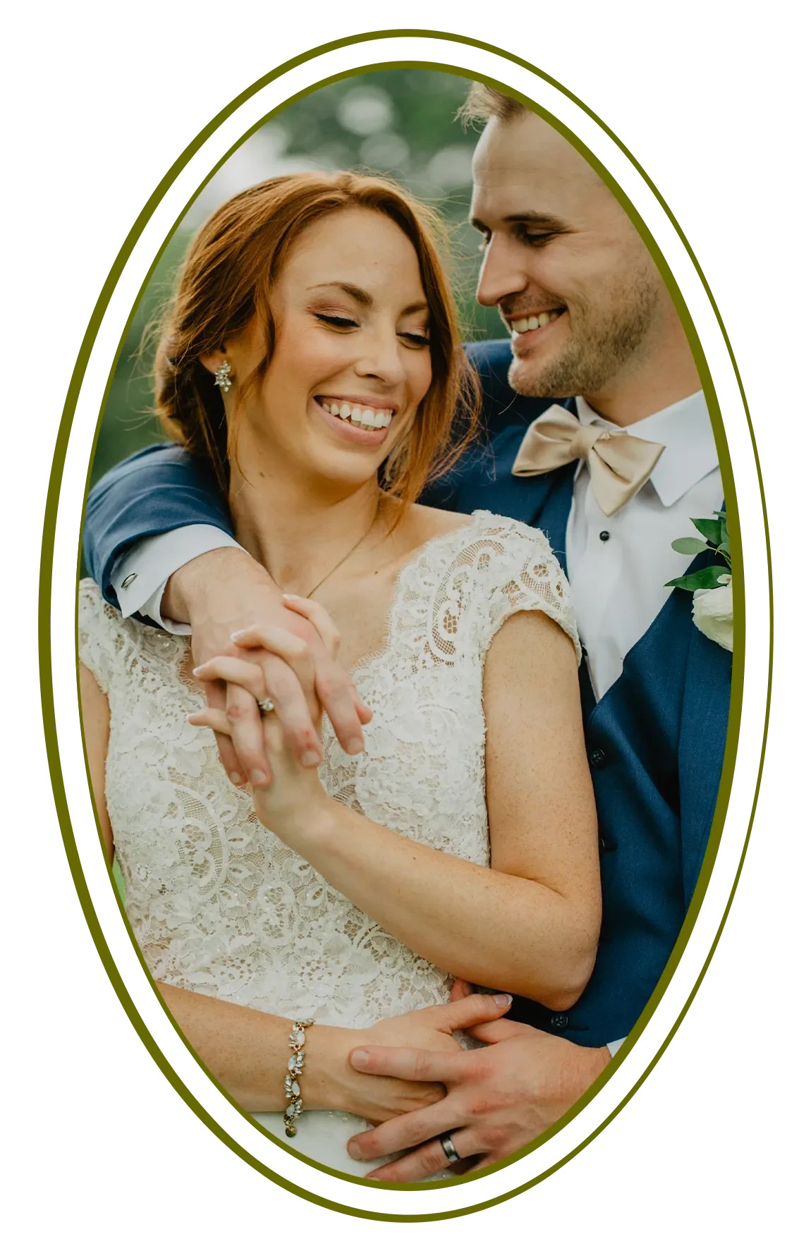 A bride and groom smiling and embracing outdoors, dressed in wedding attire, surrounded by a decorative oval border.