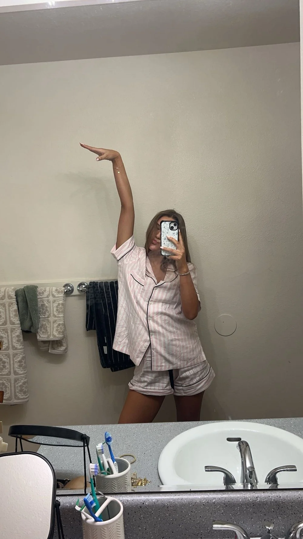 Tanned woman taking selfie in the mirror