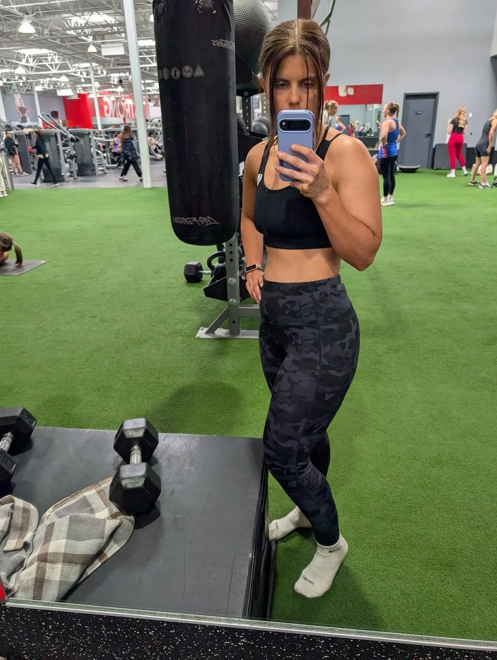 Woman with airbrush spray tan at the gym 