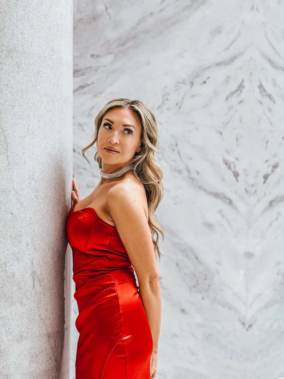 A woman in a red dress staring at the camera