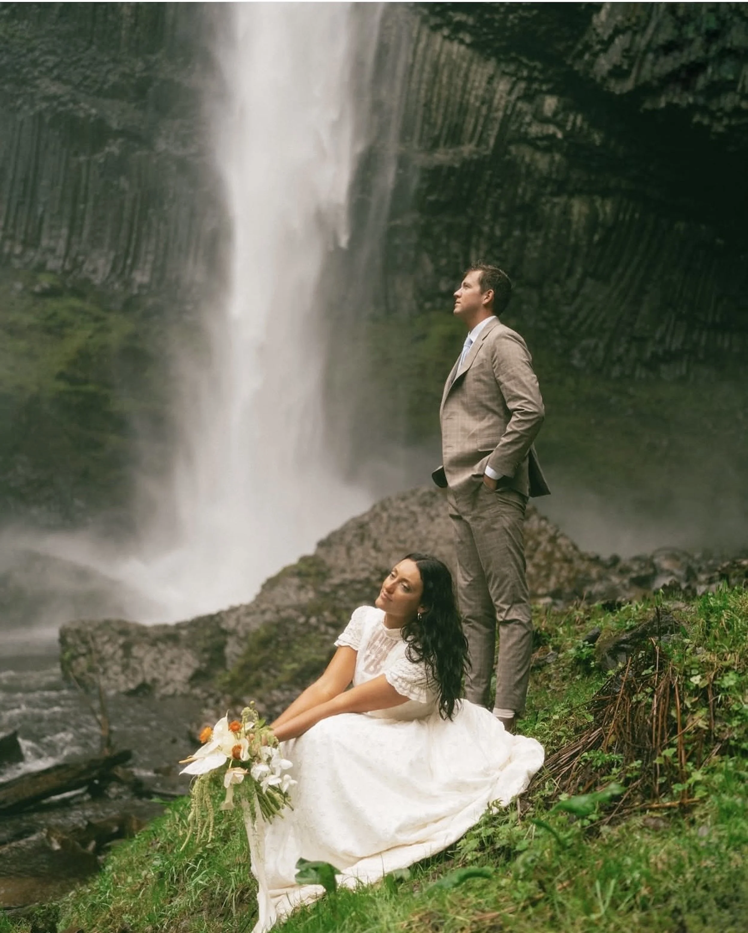 airbrushed bride and man in front of a waterfall