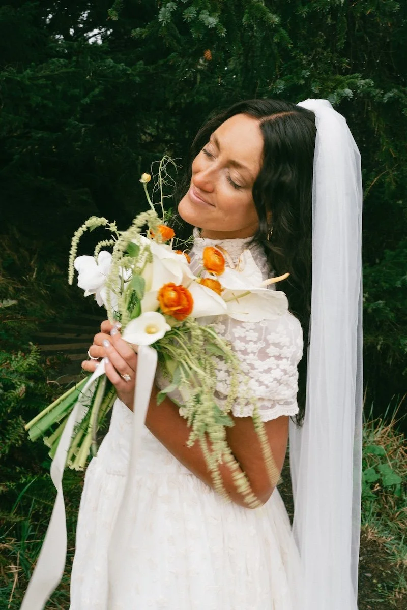 Beautifully spray tanned bride holding a bouquet