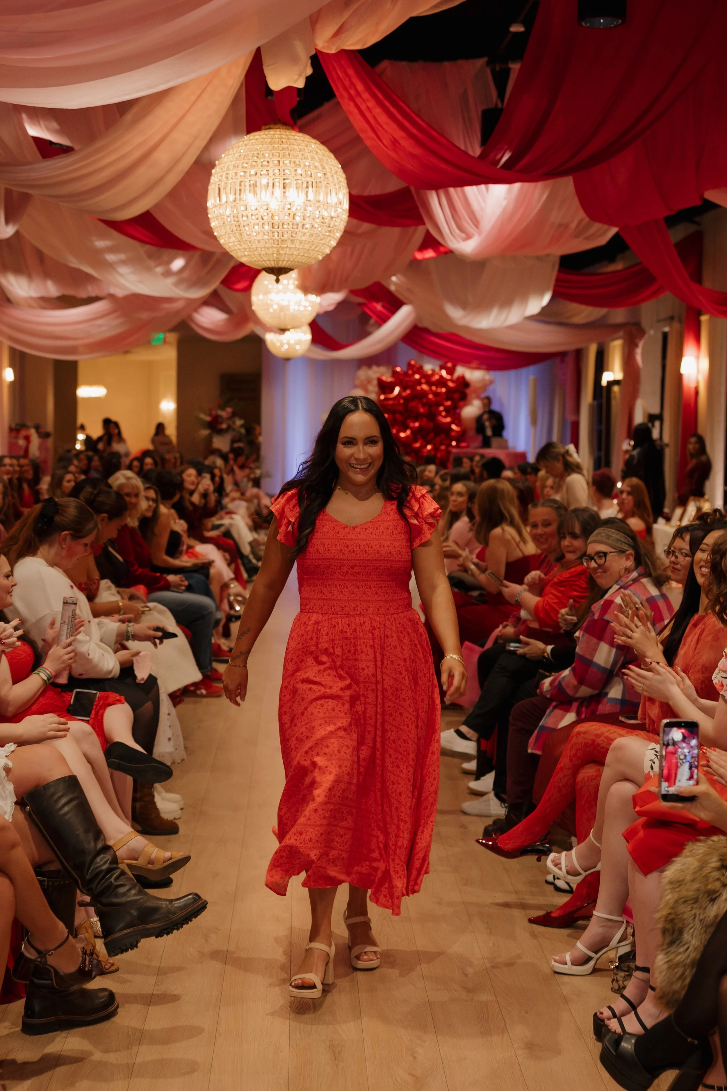 Confident tanned woman walking down runway