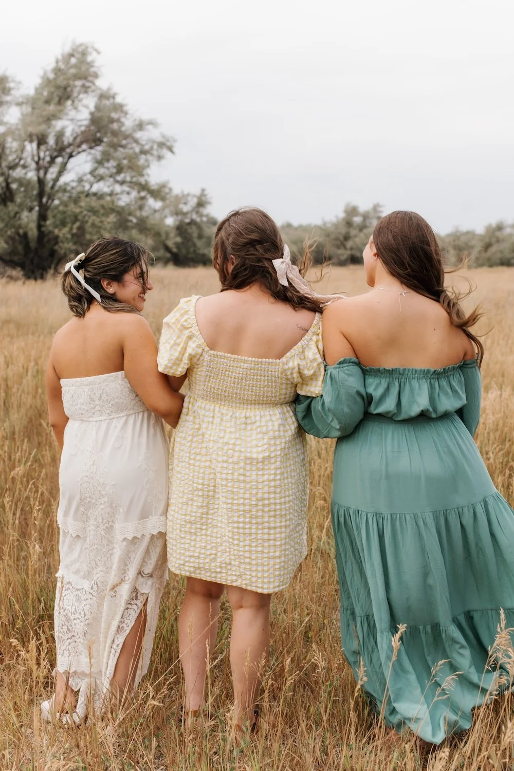 Three tanned girls in a field