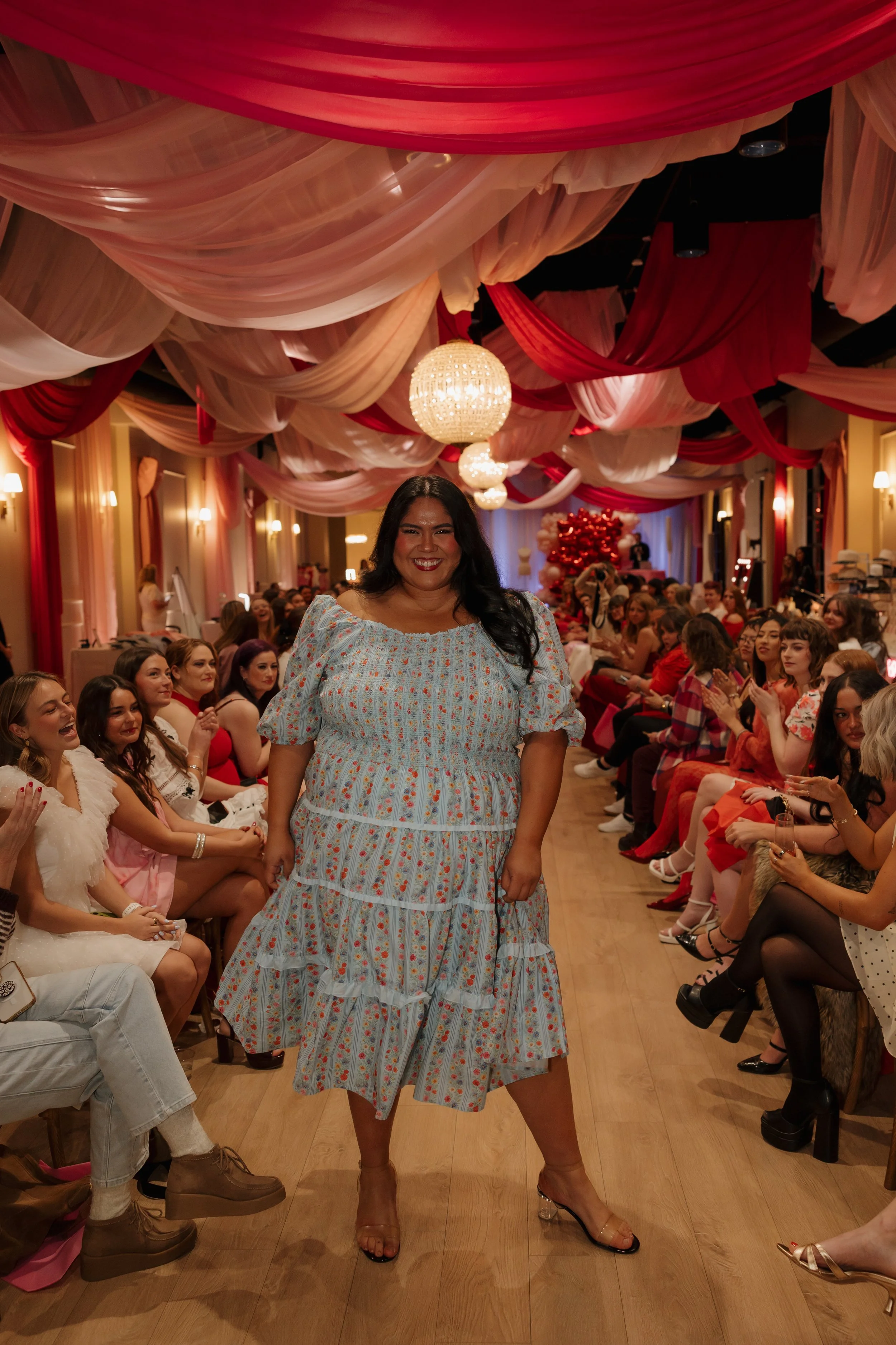 Tanned woman standing in the middle of a runway