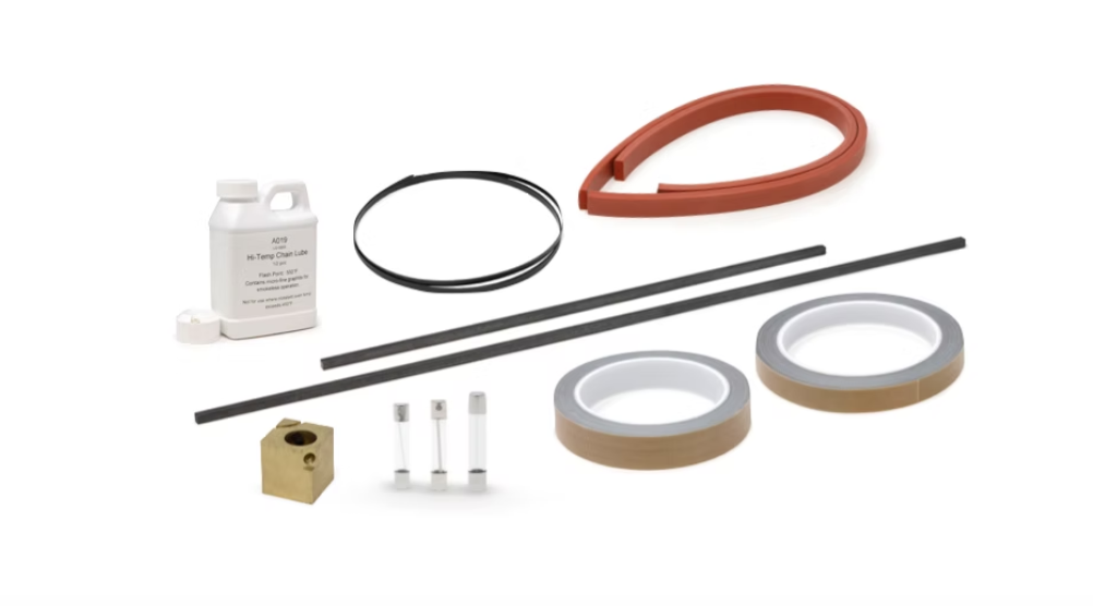 Assorted mechanical parts including a white bottle labeled "Hi-Temp Chain Lube," black rings, red curved rubber strip, two gray rubber strips with brown backing, a small beige block, and three white rods with ends.