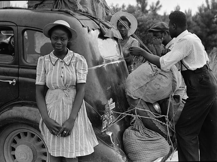 Green Book For Motorists, vintage image of young Black woman in front of car