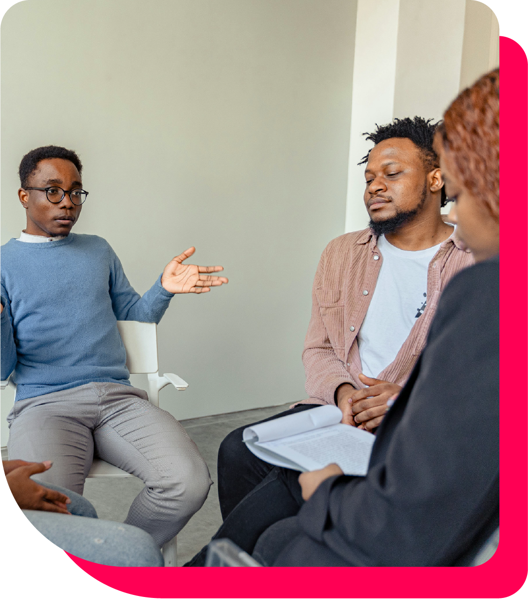 Host an educational session with the Green Book For Health, image of Black individuals gathering and discussing Black Wellness and Healthcare