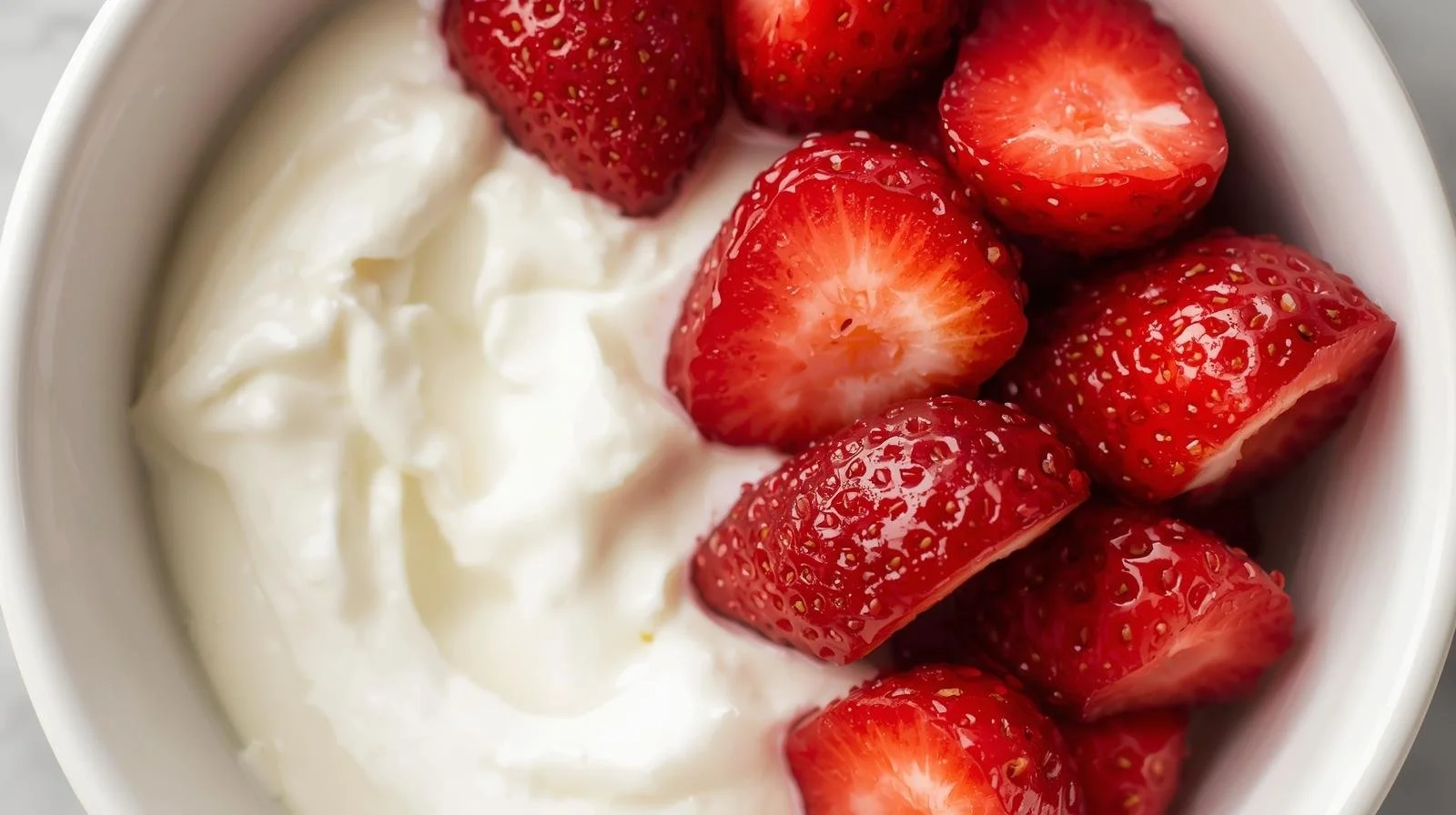image of 1 cup of sliced strawberries with 6 oz plain Greek yogurt in a bowl.jpg