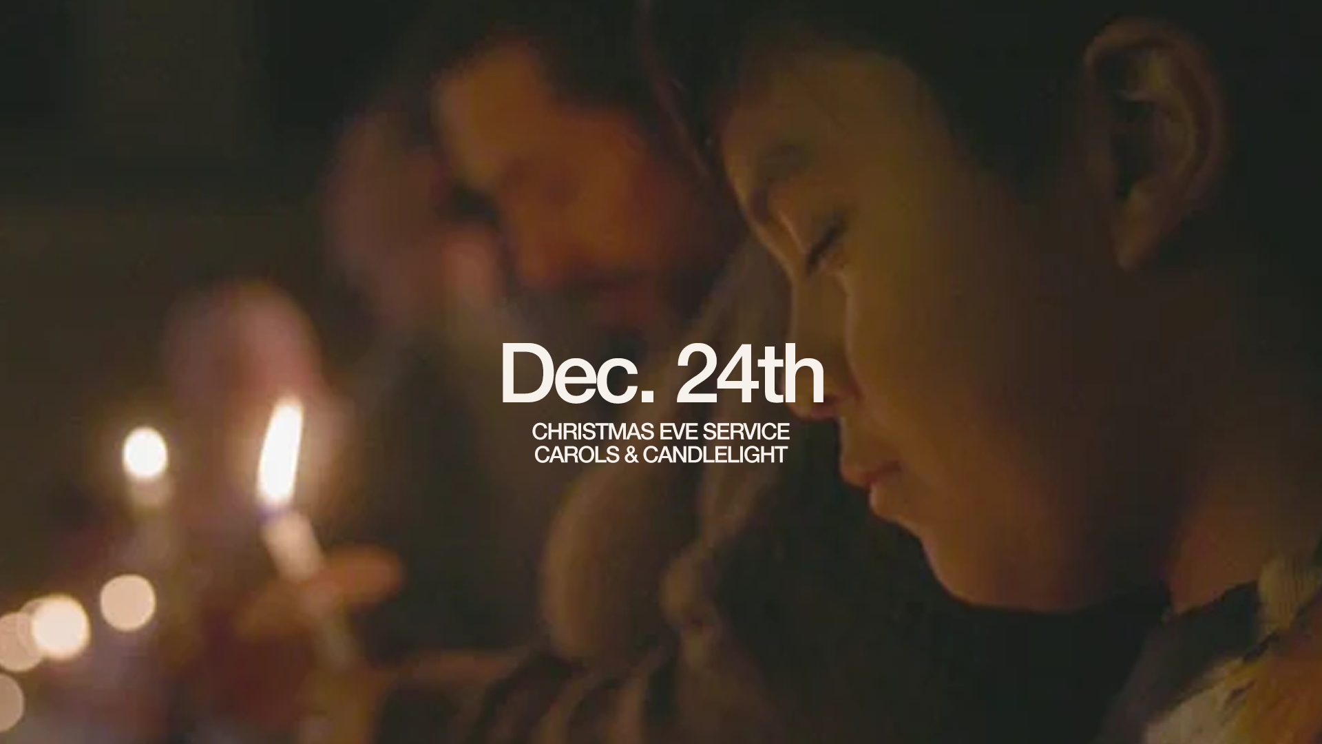 A woman in profile with closed eyes holding a candle, celebration of Christmas Eve with candlelight and carols, date Dec. 24th.