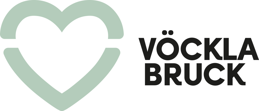 Ein Herz mit einem Kreuz im Inneren und der Text 'Vöckla Bruck' daneben.