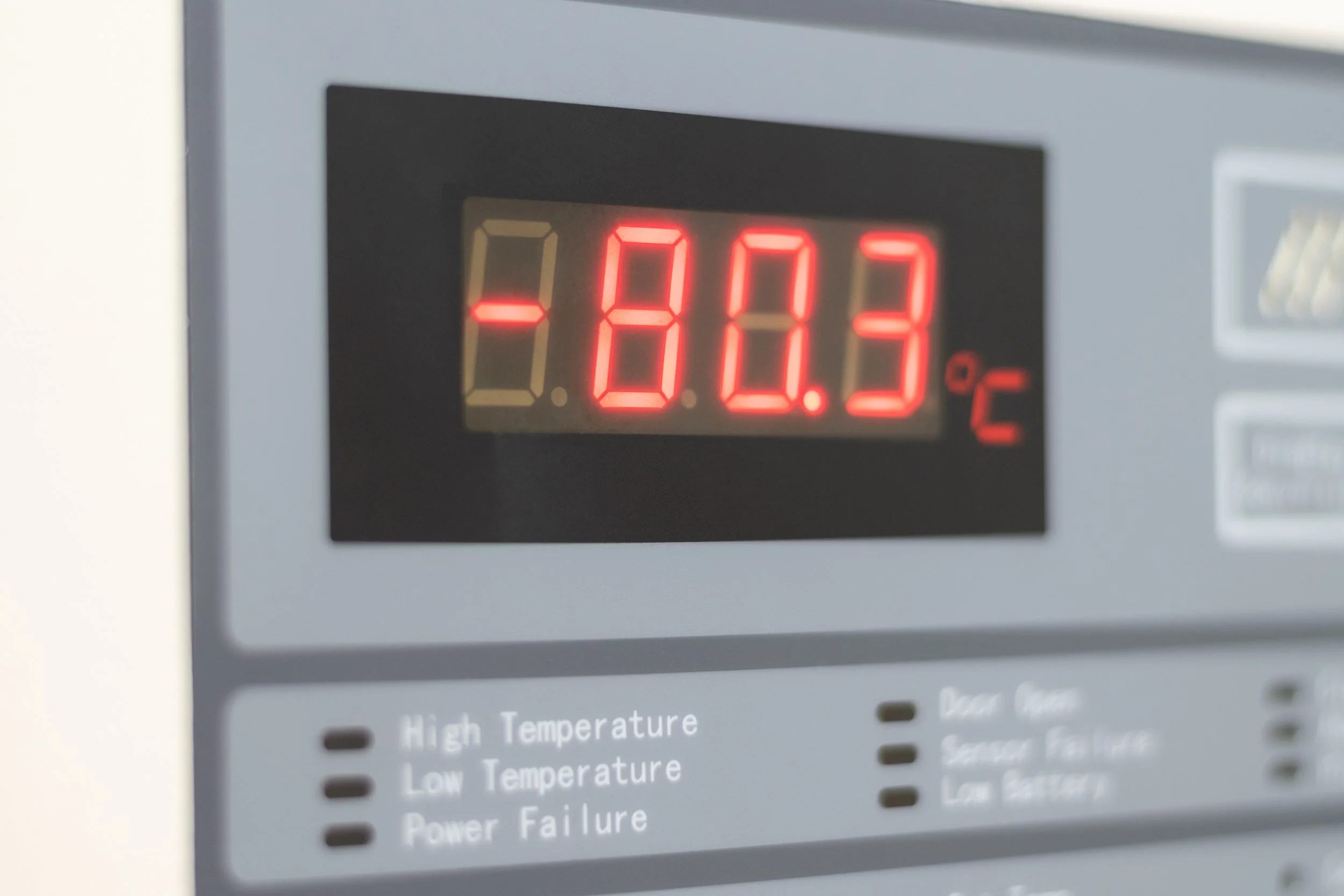 Digital display showing -80.3°C on a control panel with indicators for high temperature, low temperature, power failure, receiver temperature, and low battery.