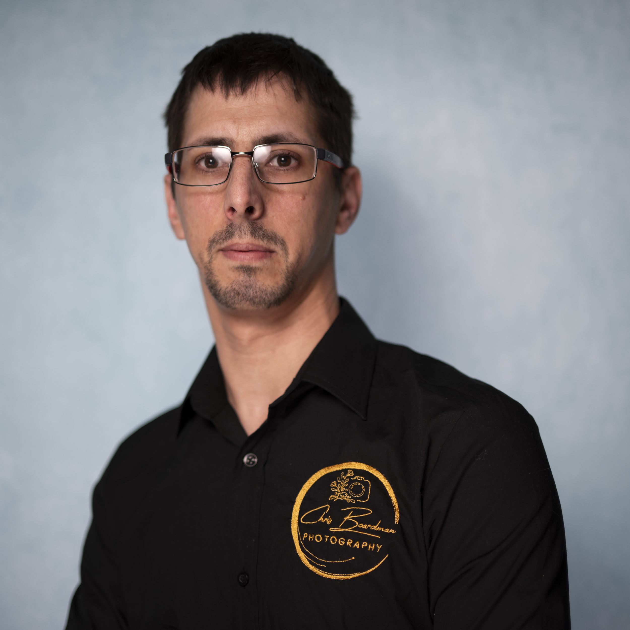 Owner of Chris Boardman Photography wearing a black shirt with the company logo on it - The Man behind the camara that captures your wonderful wedding day