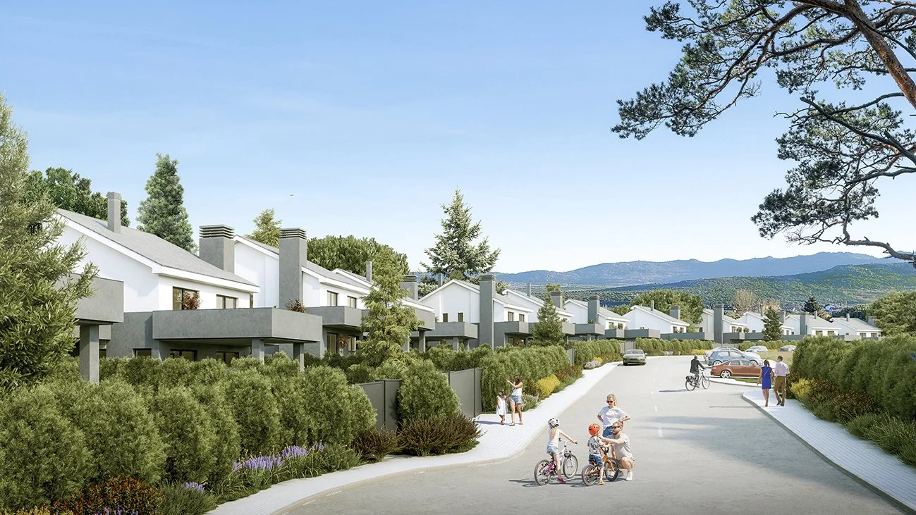 Vista de un vecindario con casas modernas y jardines verdes, con niños y adultos paseando y jugando en una vía peatonal y de bicicletas, con árboles y montañas al fondo.