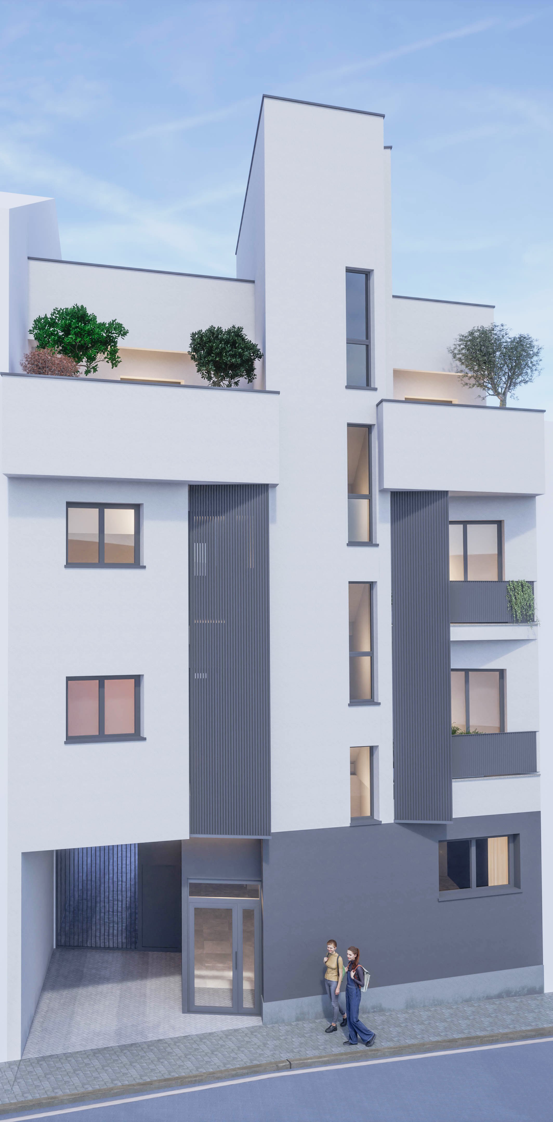 Edificio moderno de color blanco con varias ventanas y balcones, algunos con plantas y árboles en las terrazas, y dos personas caminando por la acera en primer plano.