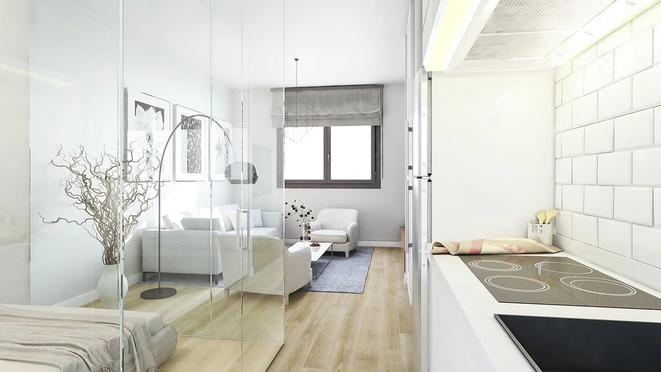 Vista de una sala de estar moderna con muebles blancos, una ventana grande y paredes decoradas con plantas y fotografías, vista parcial de una cocina con una estufa y utensilios.