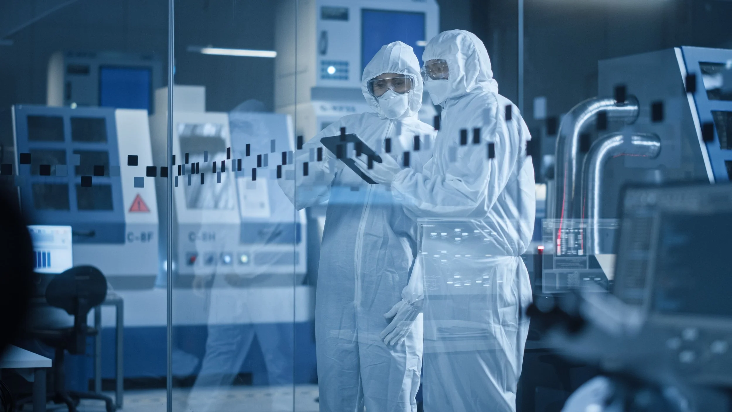 Two scientists in protective suits and masks working in a high-tech laboratory with advanced equipment and computer screens.