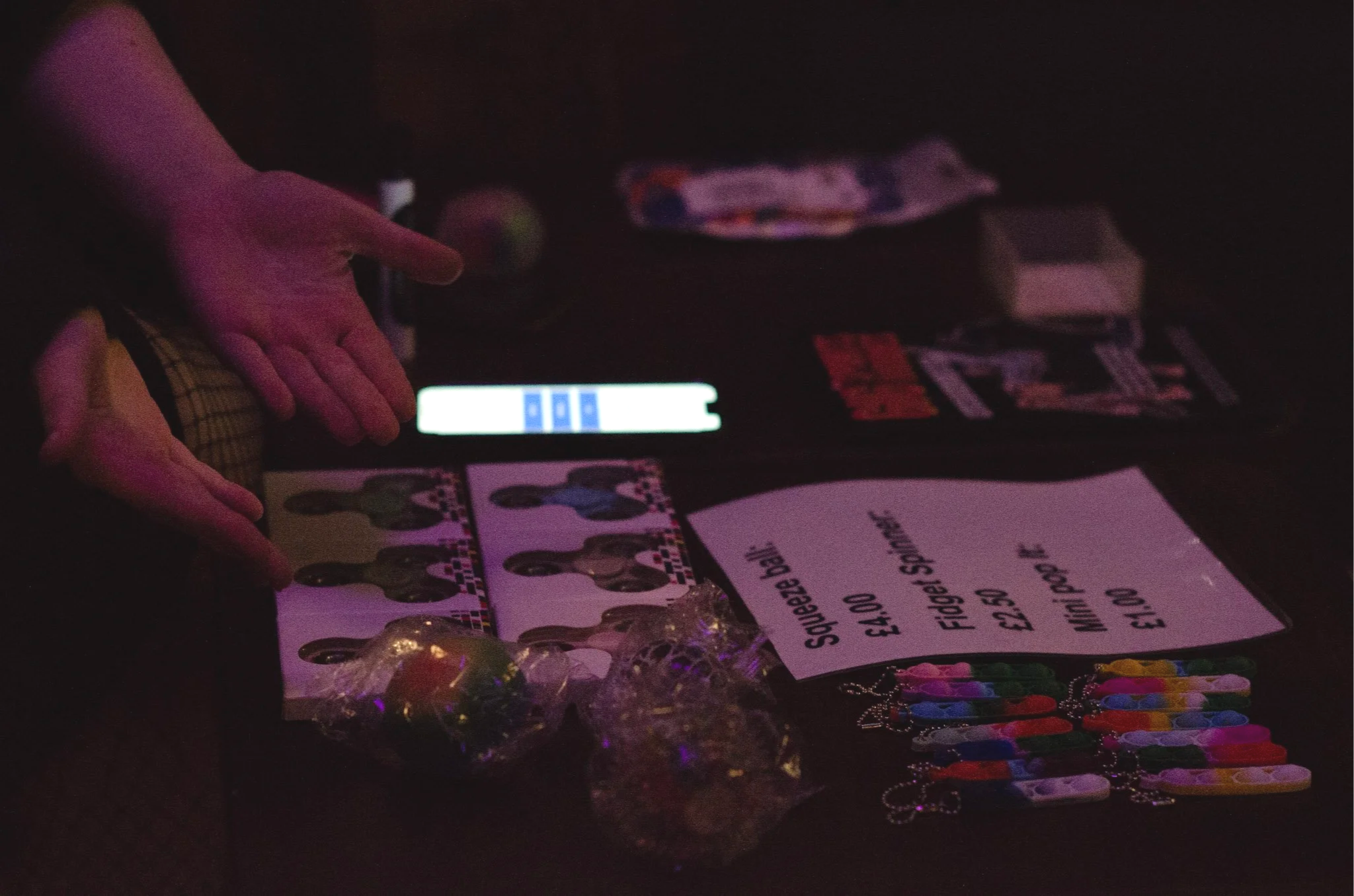 Fidget toys including pop its, fidget spinners and squish balls being sold at a sensory friendly gig.