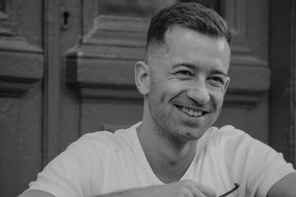 Man sitting on a front step smiling