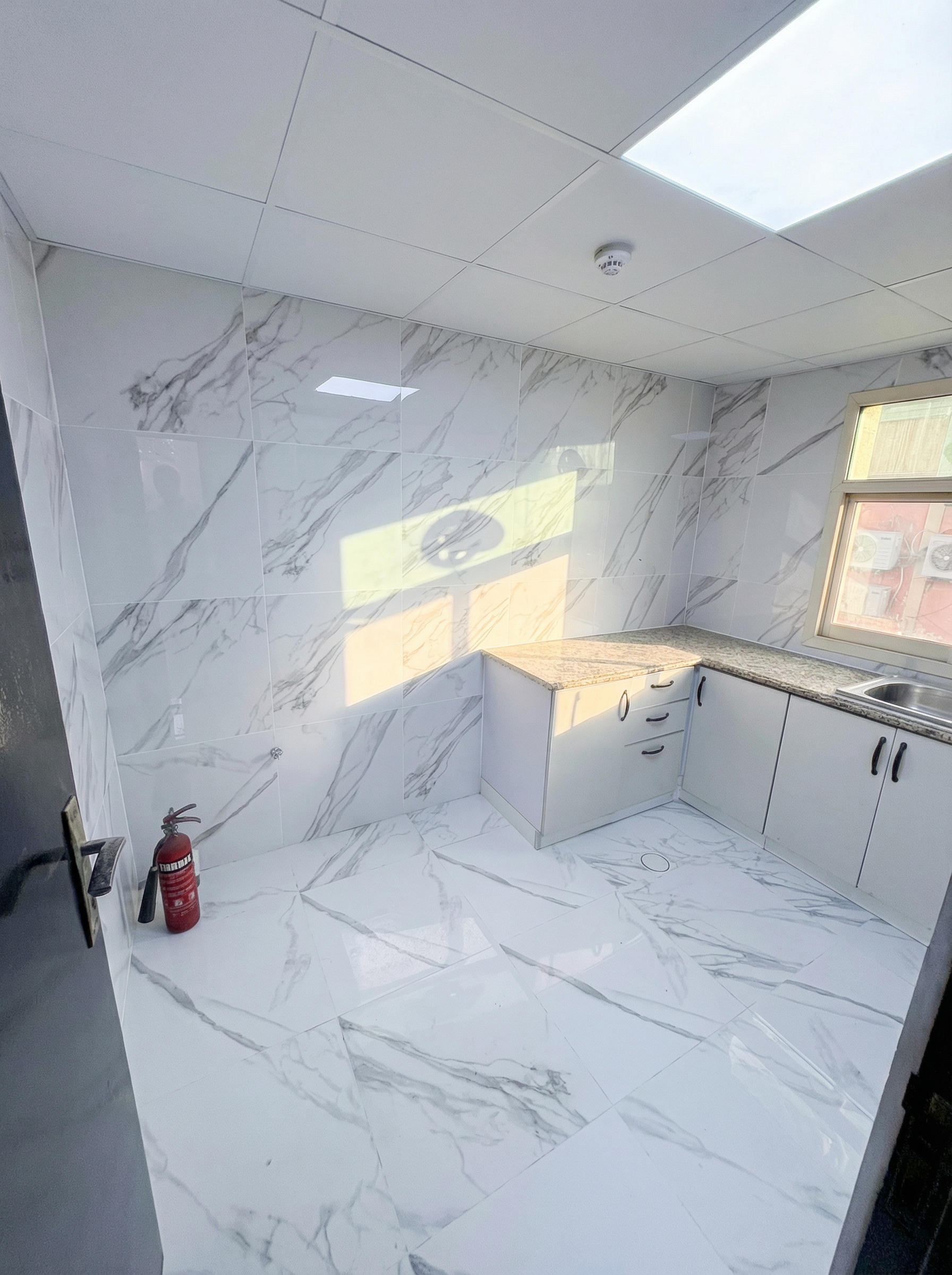 Private executive kitchen area with modern cabinetry in NDYT professional bachelor suites.