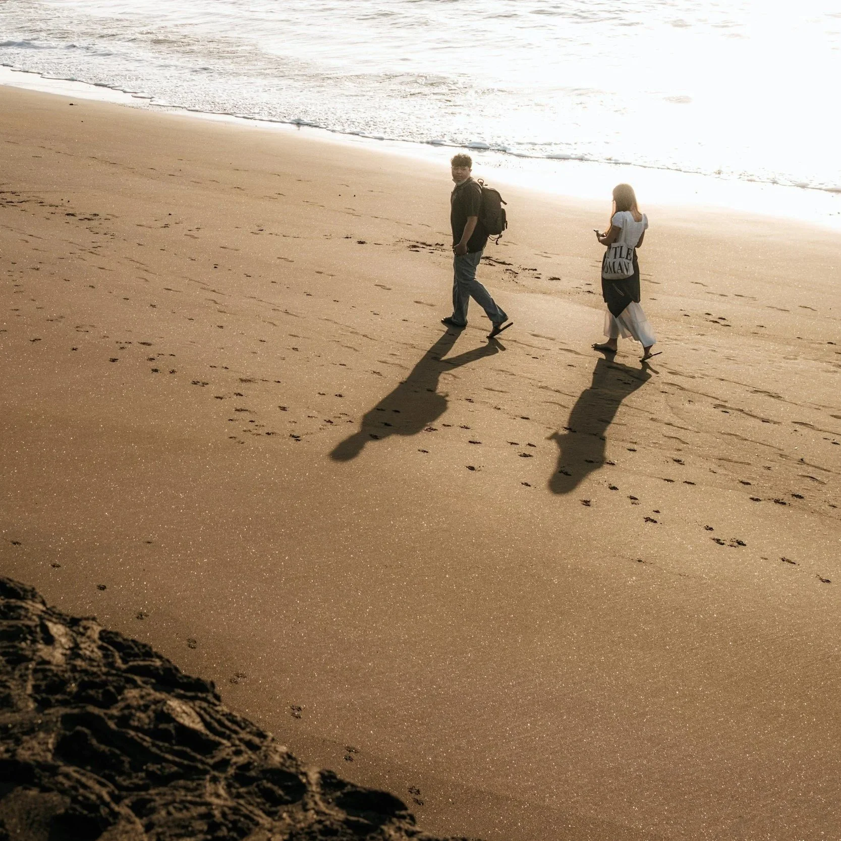 Man and woman walking on beach