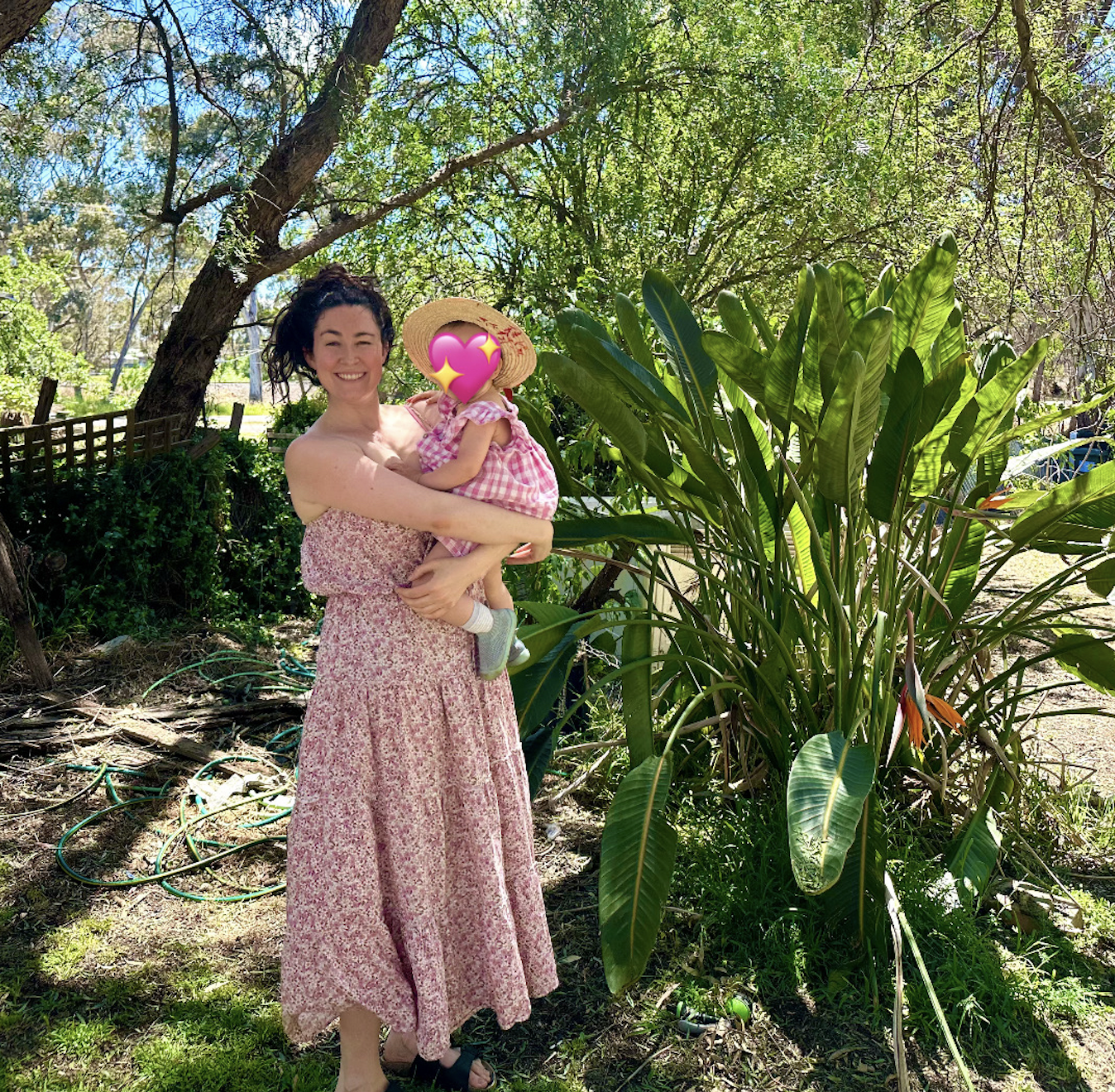Isabella Frappier holding her toddler daughter outdoors, representing motherhood alongside personal identity.