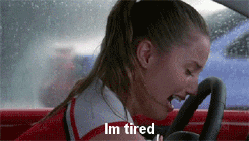 Woman crying in a car, representing feminine exhaustion at over giving