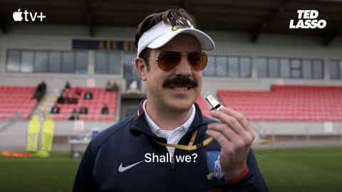 Ted Lasso playfully inviting conversation, symbolising openness, polarity, and relational dynamics in masculine and feminine energy.